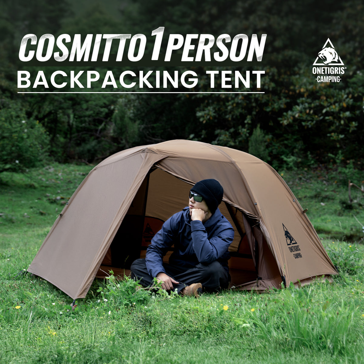 Person sitting inside a brown Cosmitto 1-person backpacking tent in a grassy area with trees.