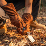Person wearing OneTigris cowhide leather gloves while using a knife for outdoor bushcraft work