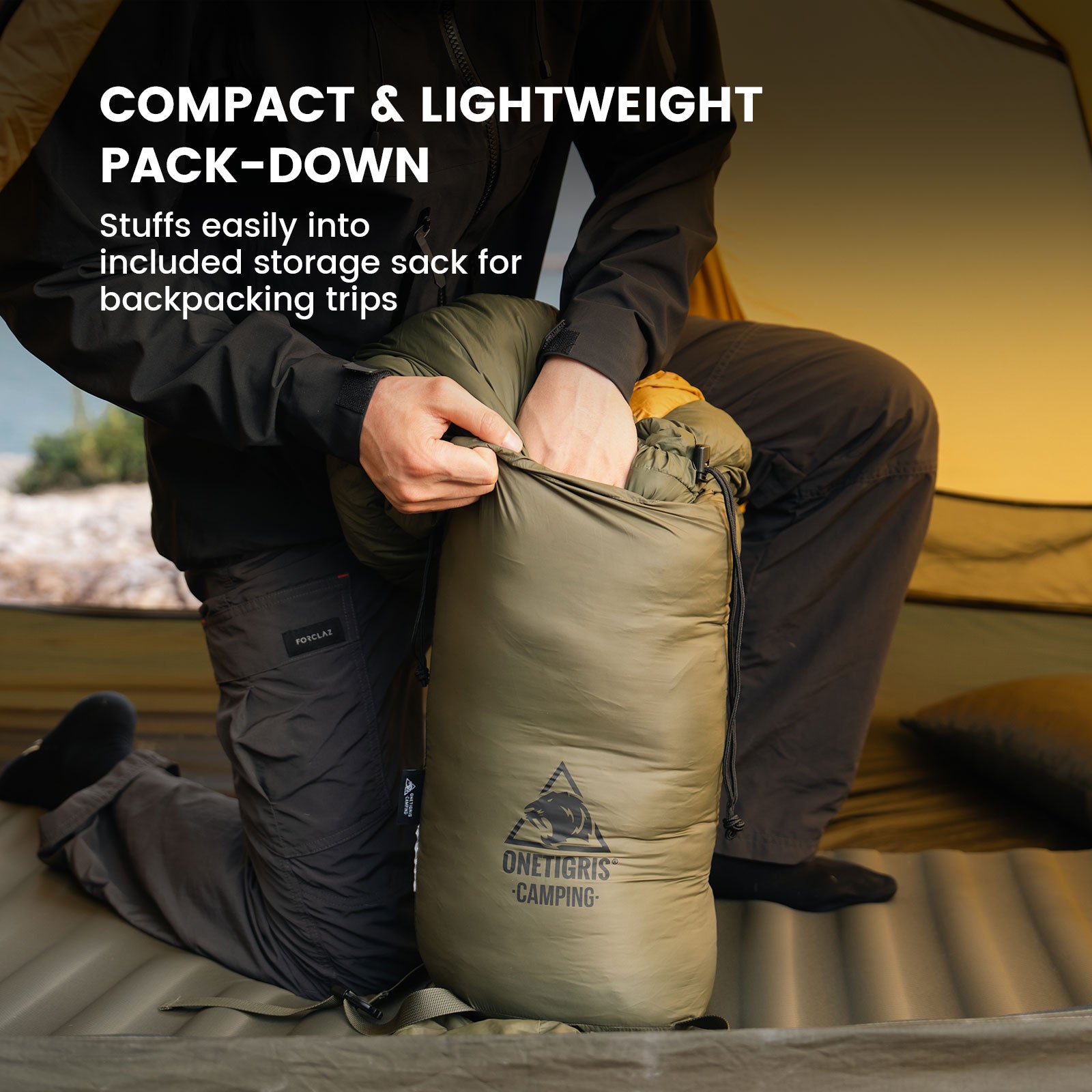 Camper compressing the OneTigris sleeping bag into its compact storage sack for backpacking trips.