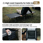 Person using a camping cot with side pockets and storage net in an outdoor setting.