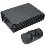 Folded gray blanket with carrying bag on a white background