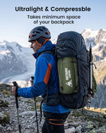 Man hiking with a large backpack on a mountain trail, featuring Ultralight & Compressible text.