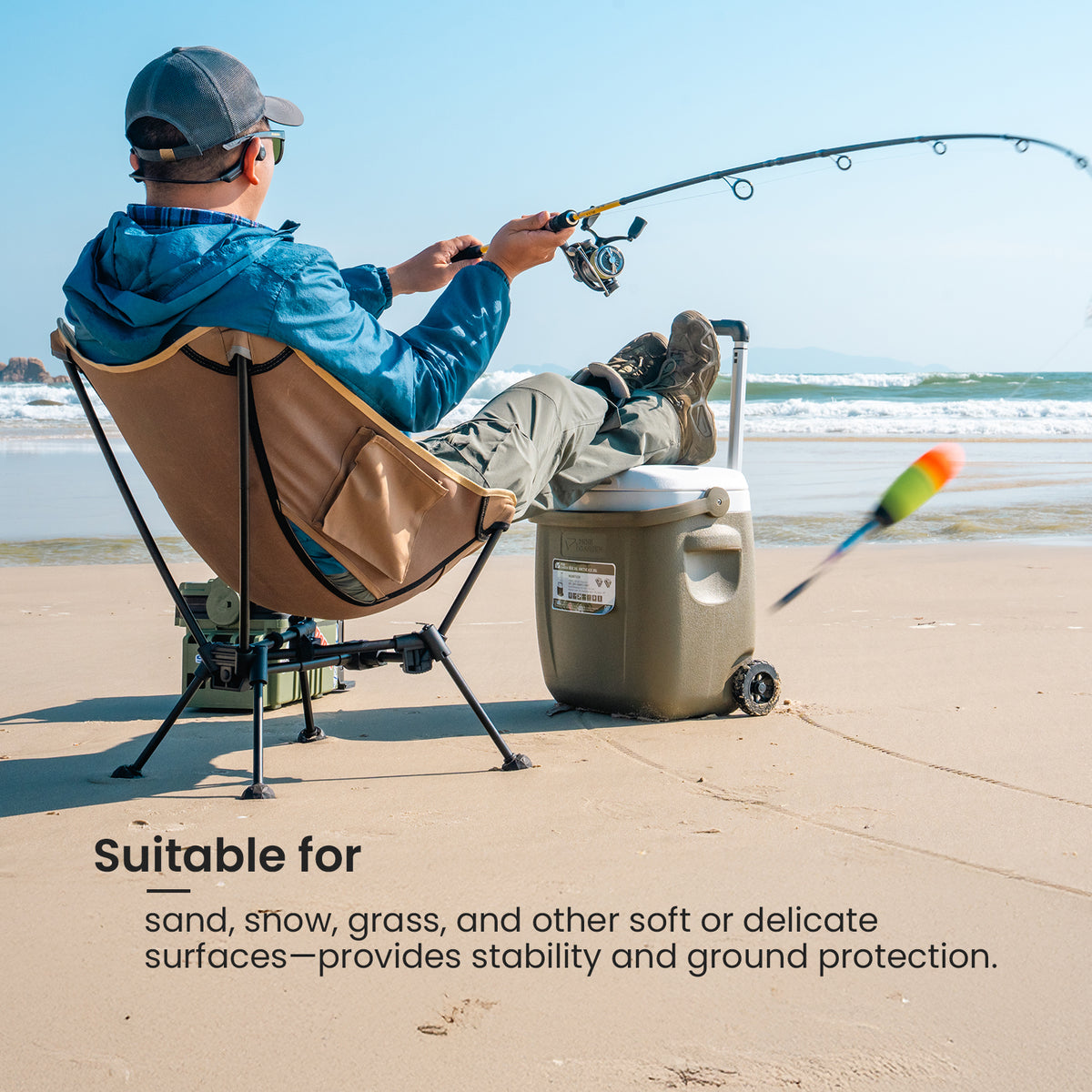 Person fishing on a beach using a portable chair with Anti-sink Ball