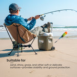 Person fishing on a beach using a portable chair with Anti-sink Ball